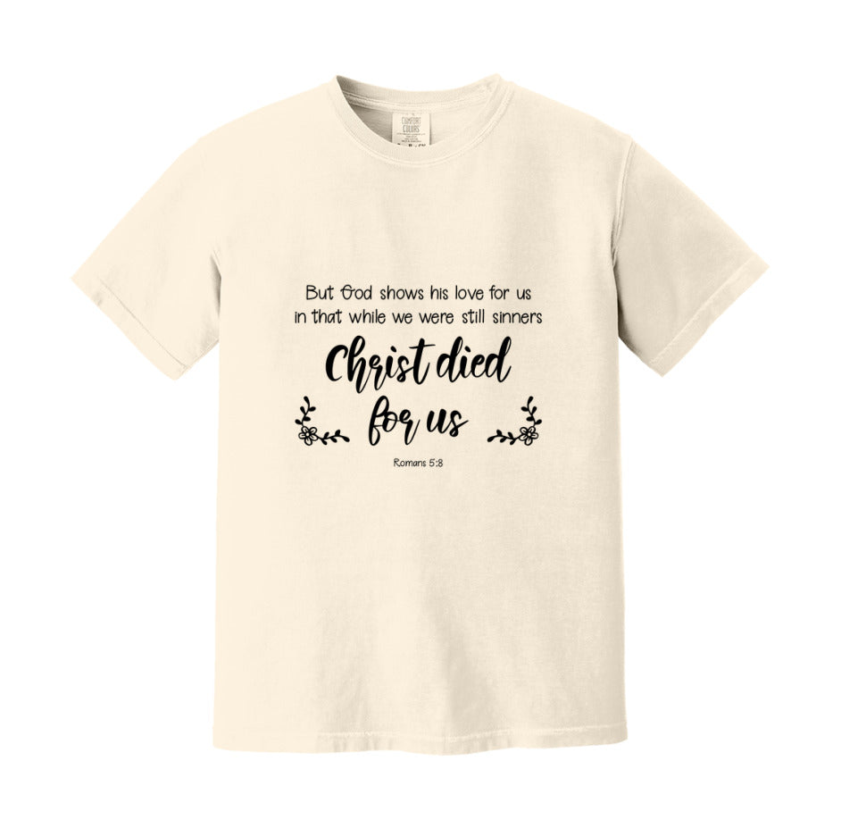 But God Shows His Love For Us In That While We Were Still Sinners Christ Died For Us T-Shirt