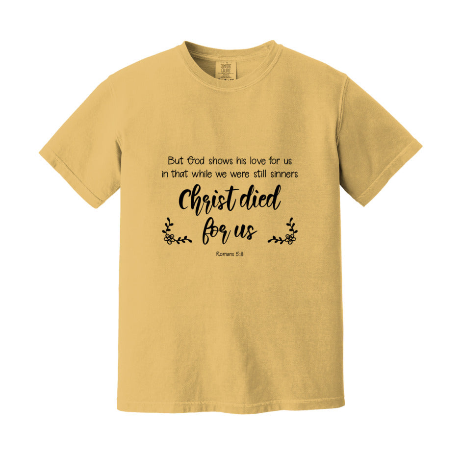 But God Shows His Love For Us In That While We Were Still Sinners Christ Died For Us T-Shirt