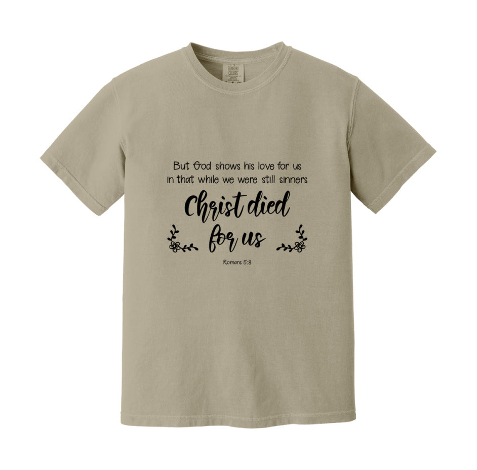 But God Shows His Love For Us In That While We Were Still Sinners Christ Died For Us T-Shirt